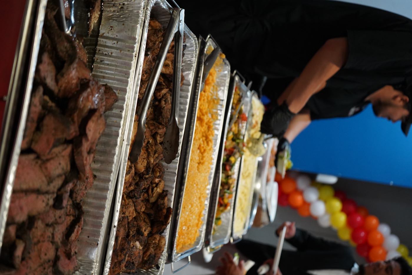 Full BBQ buffet spread with proteins and sides