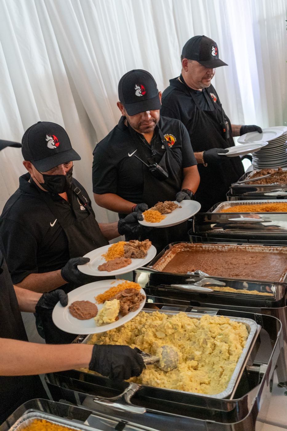 The Roosters crew plating tacos and sides